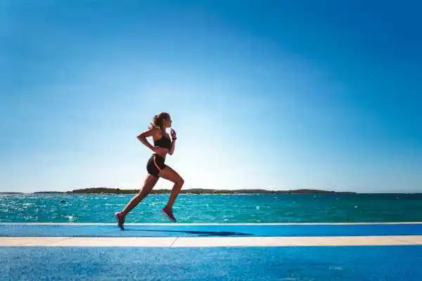 Woman running showing strong leg muscle Scottish